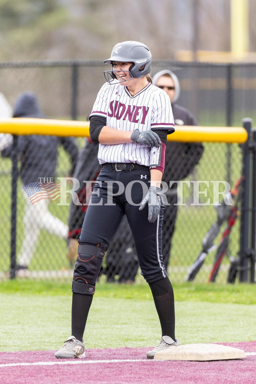 Sidney’s Ava Cirigliano smiles after reaching third base during her team’s win over Unatego Friday, April 12.